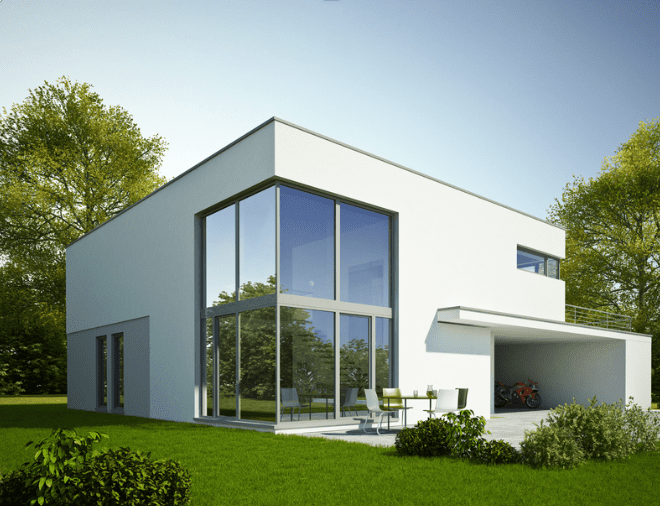 Un bâtiment blanc avec de grandes fenêtres et portes, une table à l'extérieur et un garage.